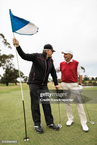 friends talking together at the golf course - golf bag stock pictures, royalty-free photos & images