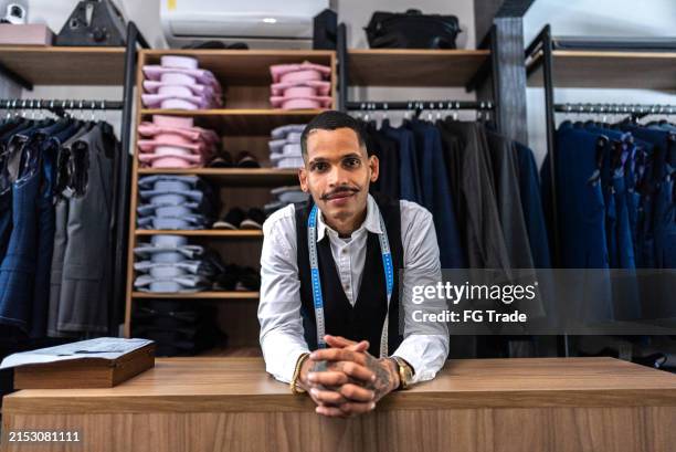 portrait of a tailor at clothing store - boutique stock pictures, royalty-free photos & images