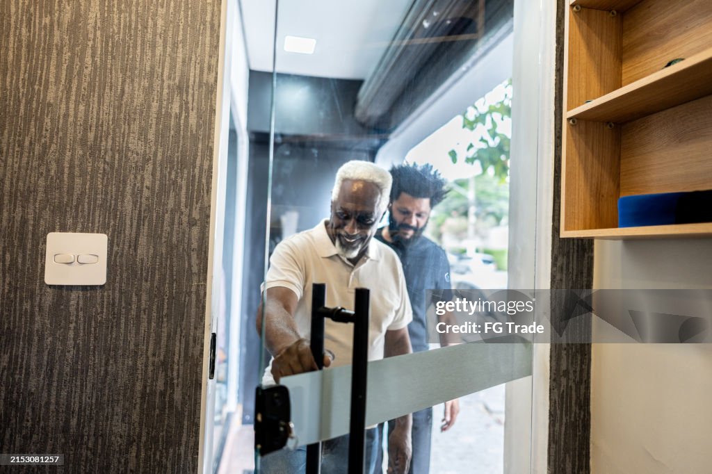 Father and son entering at store