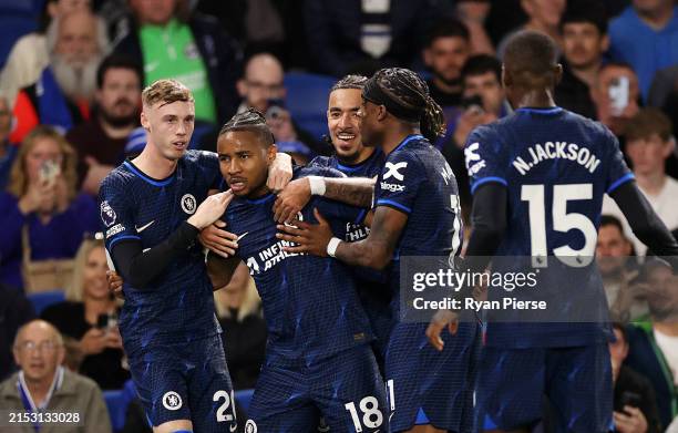 Christopher Nkunku of Chelsea celebrates scoring his team's second goal with teammates during the Premier League match between Brighton & Hove Albion...