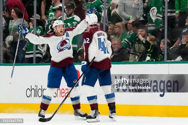 Nathan MacKinnon of the Colorado Avalanche celebrates a goal with teammate Josh Manson against the Dallas Stars during the third period in Game Five...