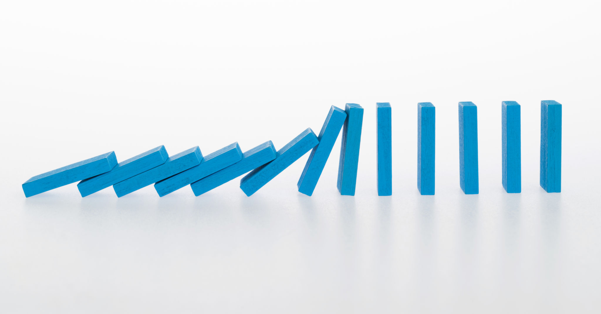 Falling dominoes on white background Falling dominoes on white background