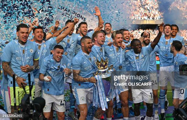Manchester City's English defender Kyle Walker holds aloft the Premier League trophy during the presentation ceremony following the English Premier...