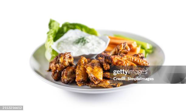 hot and spicey buffalo chicken wings with celery, carrot and tzatziki sauce. - main course stock pictures, royalty-free photos & images