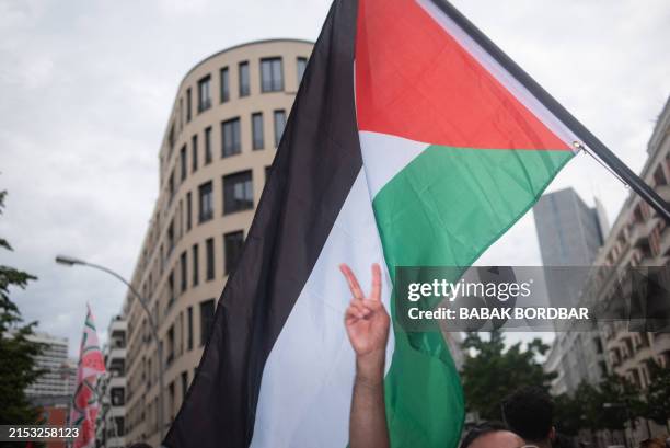 Protester waves a Palestinian flag during a Pro-Palestine demonstration held in Berlin, Germany, on May 18, 2024. Hundreds of people rallied in...