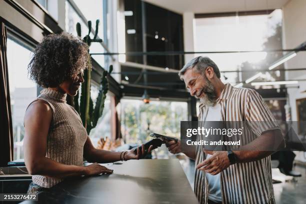 contactless payment with smartphone - contactless payment stock pictures, royalty-free photos & images