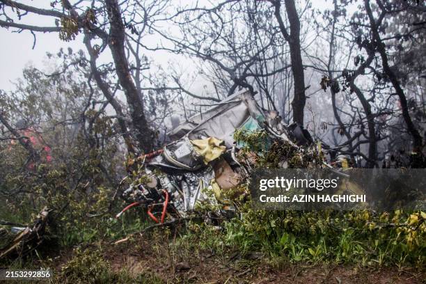 Picture shows wreckage at the crash site of a helicopter transporting Iran's President, his Foreign Minister, and others in a fog-covered mountainous...