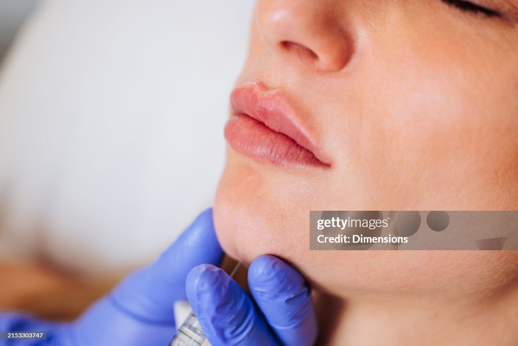 Close-up of a chin injection procedure