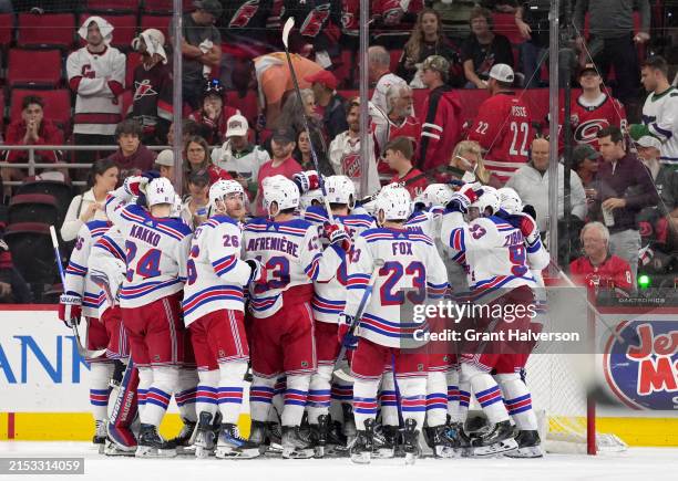 Members of the New York Rangers celebrate a series win against the Carolina Hurricanes during the third period in Game Six of the Second Round of the...