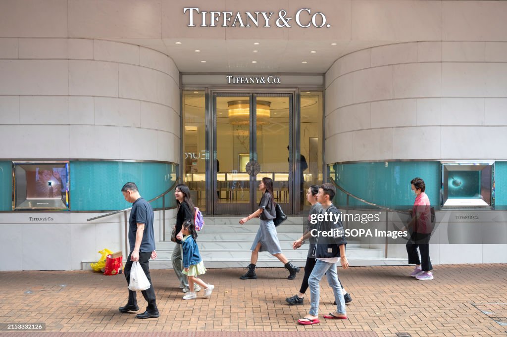 Pedestrians walk past the American luxury jewelry company...