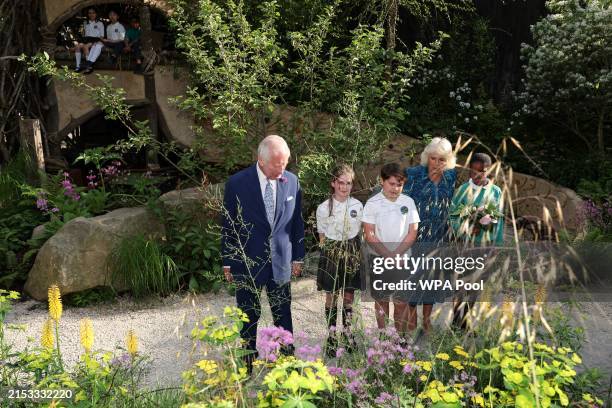 Britain's King Charles III and Britain's Queen Camilla meet with pupils of the Sulivan Primary school as they visit the No Adults Allowed Garden,...