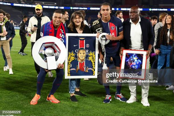 Kylian Mbappe of Paris Saint-Germain and Ethan Mbappe of Paris Saint-Germain pose with their mother Fayza Lamari and their father Wilfried Mbappe...