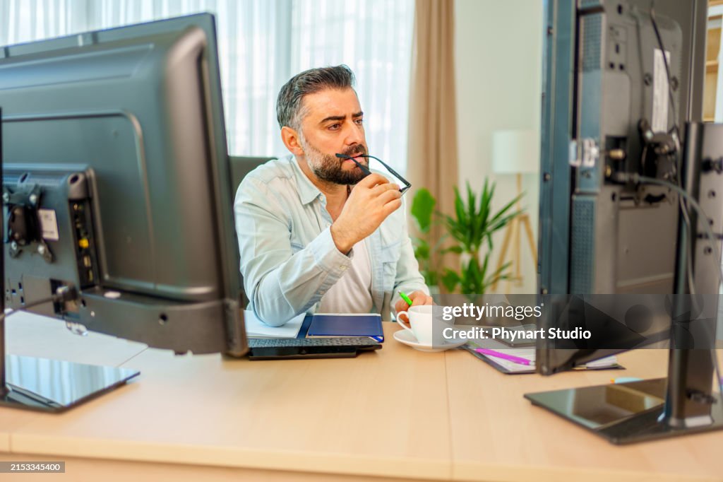 Tired Young Caucasian Employee Looking At Computer Monitor While ...