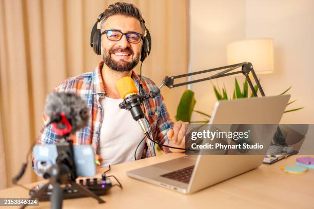 mature man recording a podcast in a home studio - radio dj stock pictures, royalty-free photos & images