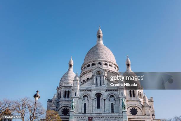 sacre coeur basilica in paris on a clear day - basilica stock pictures, royalty-free photos & images
