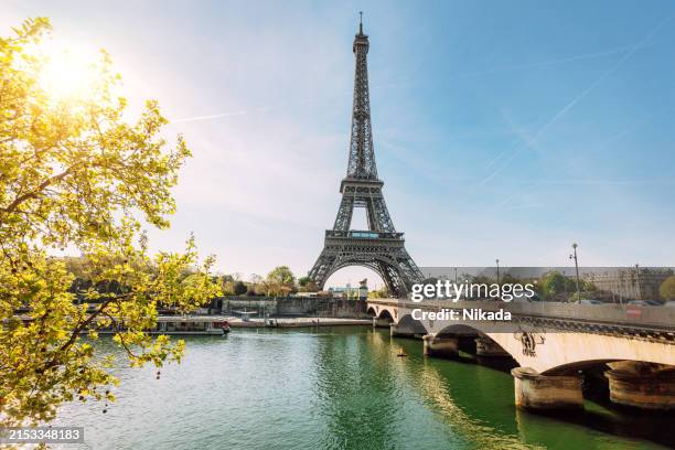 eiffel tower with bridge over river in paris, france - seine river stock pictures, royalty-free photos & images