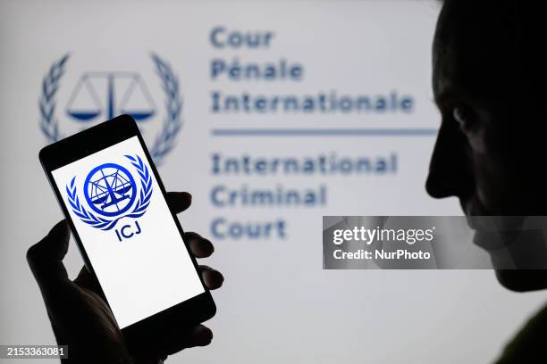 The International Court of Justice seal is being displayed on a smartphone with ICJ visible in the background in this photo illustration in Brussels,...