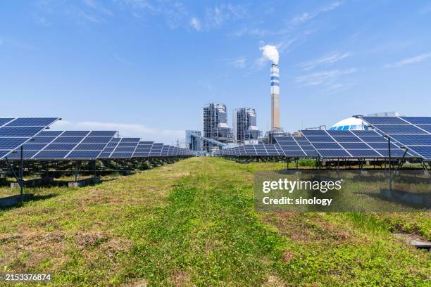 solar panels with thermal power station - power station stock pictures, royalty-free photos & images