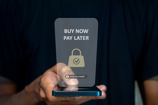 A man using a smart phone for online shopping with pay later. Buy now pay later online shopping concept.