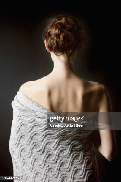 back view of woman wrapped in blanket - human back skin stock pictures, royalty-free photos & images