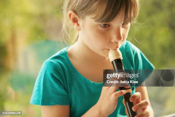 young girl playing recorder - flauto dolce foto e immagini stock