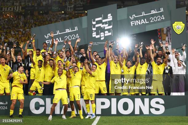 Ali Hassan Ali Salmin Al Bloushi, Ali Saleh Ali Saleh Amro and Fabio Virginio De Lima of Al Wasl lift the Presidential Cup trophy after winning the...
