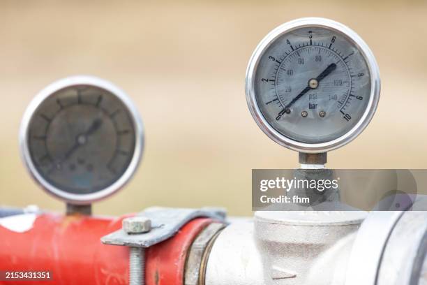 two gauges on a pipe - druckmesser stock-fotos und bilder