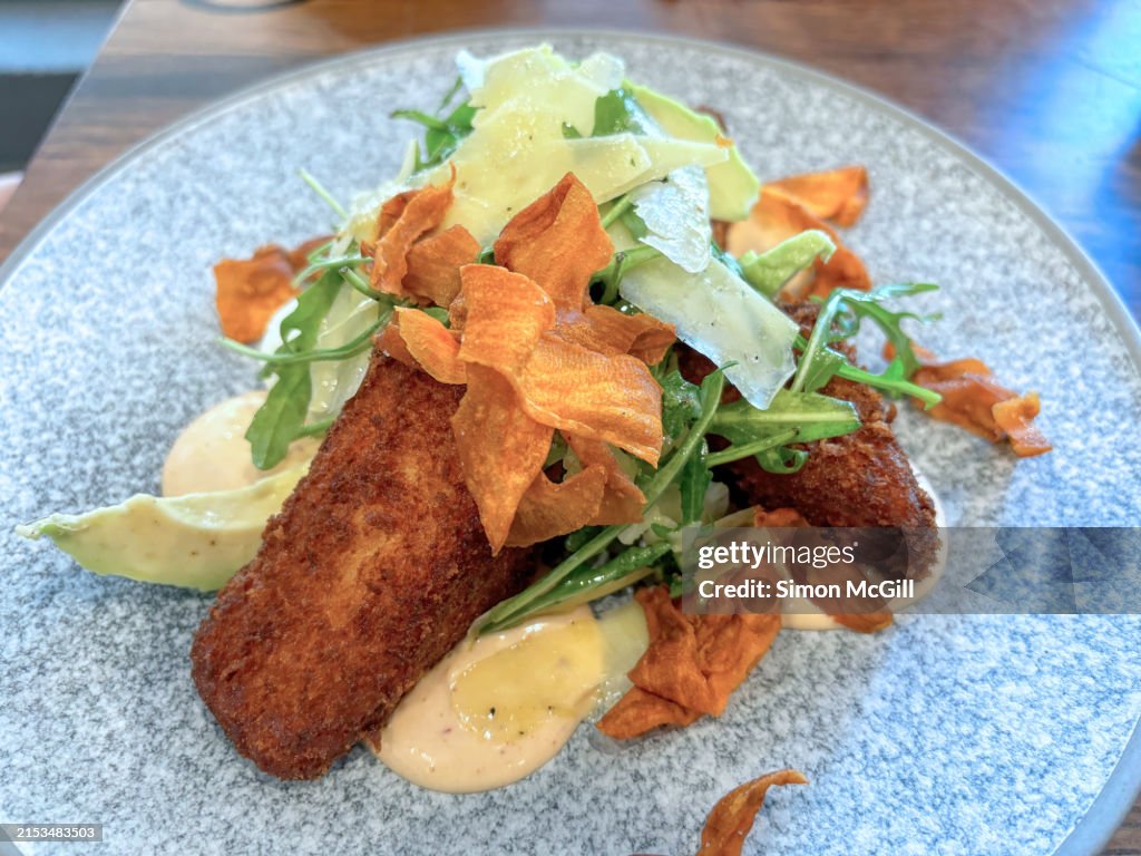 Spiced sweet potato cakes with chipotle aioli, avocado, rocket/arugula and pecorino cheese shavings