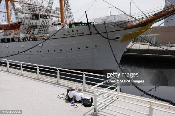 Japanese school children make drawings of the museum ship Nippon Maru.