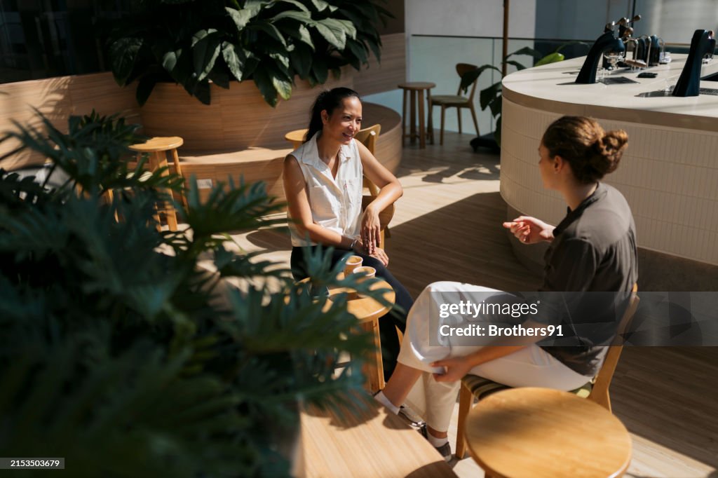 Two friends indulge in meaningful conversation at cafe