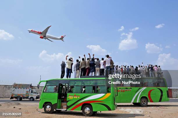 Relatives are standing atop buses as they see off Haj pilgrims, leaving on a flight, in Jaipur, Rajasthan, India, on May 21, 2024.