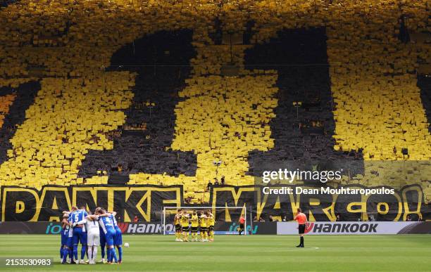 Fans of Borussia Dortmund display a number '11' mosaic and a banner reading "Danke Marco!" prior to the Bundesliga match between Borussia Dortmund...