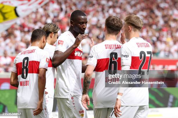 Sehrou Guirassy of VfB Stuttgart celebrates scoring his team's first goal with teammates during the Bundesliga match between VfB Stuttgart and...
