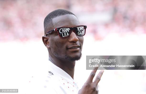 Sehrou Guirassy of VfB Stuttgart celebrates whilst wearing sunglasses displaying the text "Champions League" after the team's victory in the...