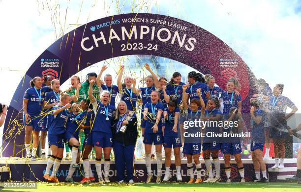 Emma Hayes, Manager of Chelsea, celebrates as she holds the Barclays Women's Super League title trophy following the team's victory in the Barclays...
