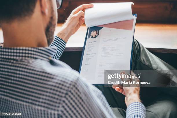 businessman or hr manager is reviewing resume information. - werkloos stockfoto's en -beelden