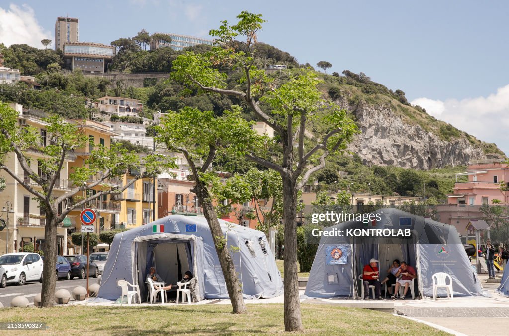 People outside the tents set up in Pozzuoli in the seafront...