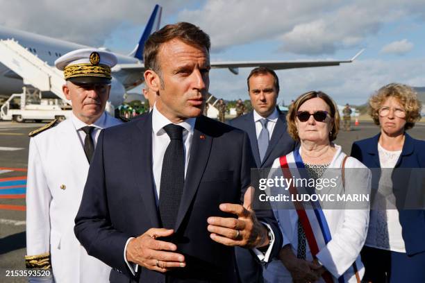 French President Emmanuel Macron speaks with the press upon arrival at Noumea La Tontouta International airport, in Noumea, France's Pacific...