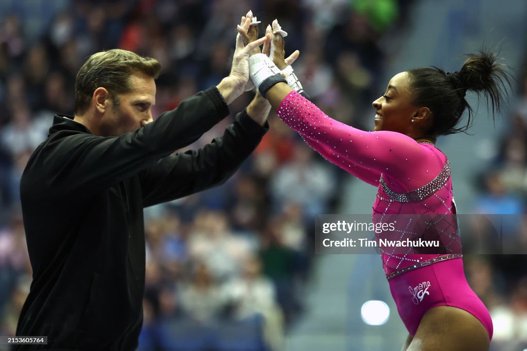 Simone Core Simone Biles celebrates after performing on the uneven bars during ...