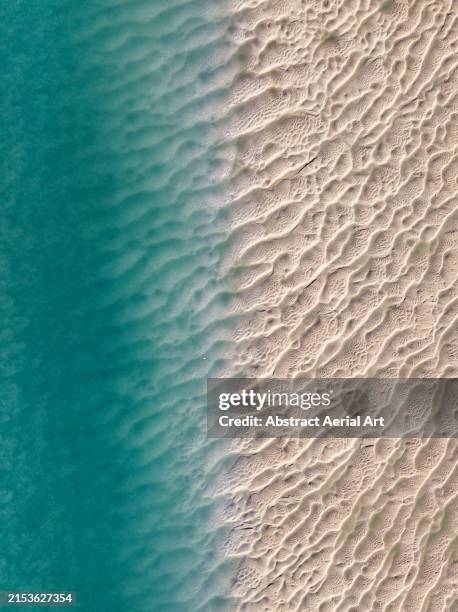 composed drone image showing a textured beach in willie creek, the kimberley, western australia, australia - sandbar stock pictures, royalty-free photos & images