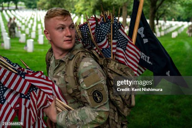 Specialist James Tomchak, Gainesville, FL, and other members of the 3rd U.S. Infantry Regiment, also known as the "Old Guard," place flags at the...