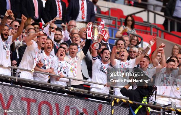 Dion Conroy of Crawley Town lifts the Sky Bet League Two Play-Off Final trophy after the team's victory in the Sky Bet League Two Play-Off Final...