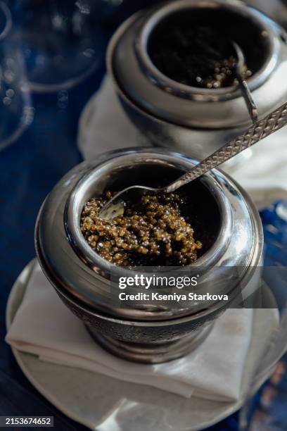 metal bowl with black caviar on ice - caviar stock pictures, royalty-free photos & images