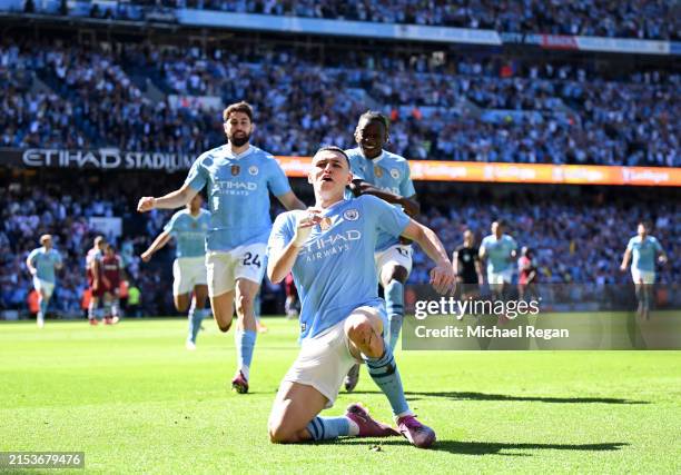 Phil Foden of Manchester City celebrates scoring his team's first goal during the Premier League match between Manchester City and West Ham United at...