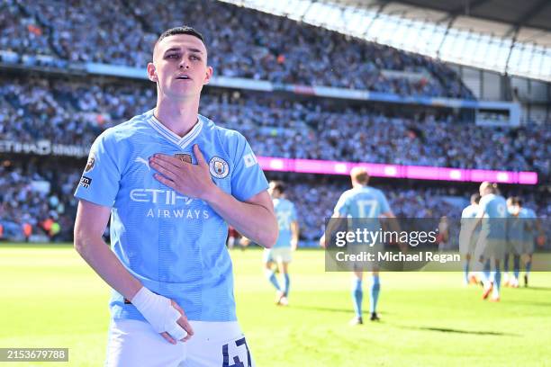 Phil Foden of Manchester City celebrates scoring his team's first goal during the Premier League match between Manchester City and West Ham United at...