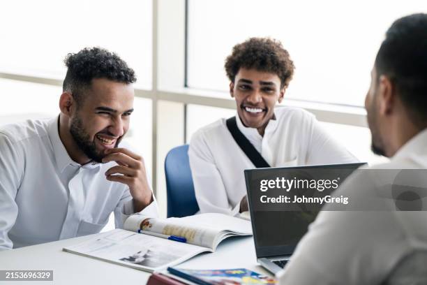 relaxed young saudi students preparing for class - arab boy stock pictures, royalty-free photos & images