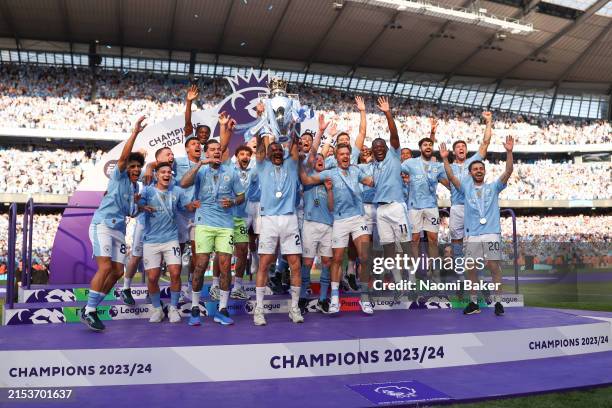 Kyle Walker of Manchester City lifts the Premier League Trophy after their team's victory during the Premier League match between Manchester City and...