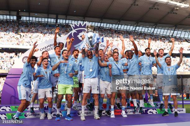 Kyle Walker of Manchester City lifts the Premier League Trophy after their team's victory during the Premier League match between Manchester City and...