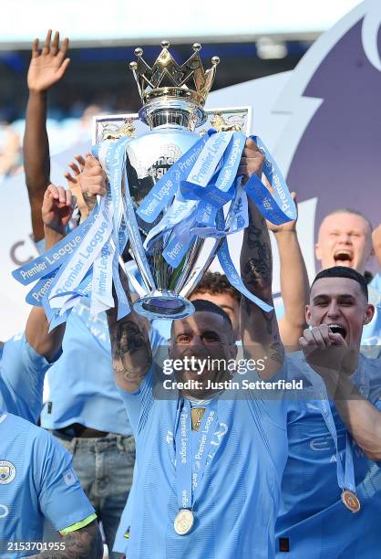 Kyle Walker of Manchester City lifts the Premier League Trophy after their team's victory during the Premier League match between Manchester City and...
