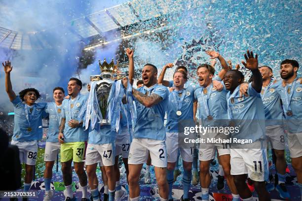 Kyle Walker of Manchester City lifts the Premier League Trophy after their team's victory during the Premier League match between Manchester City and...